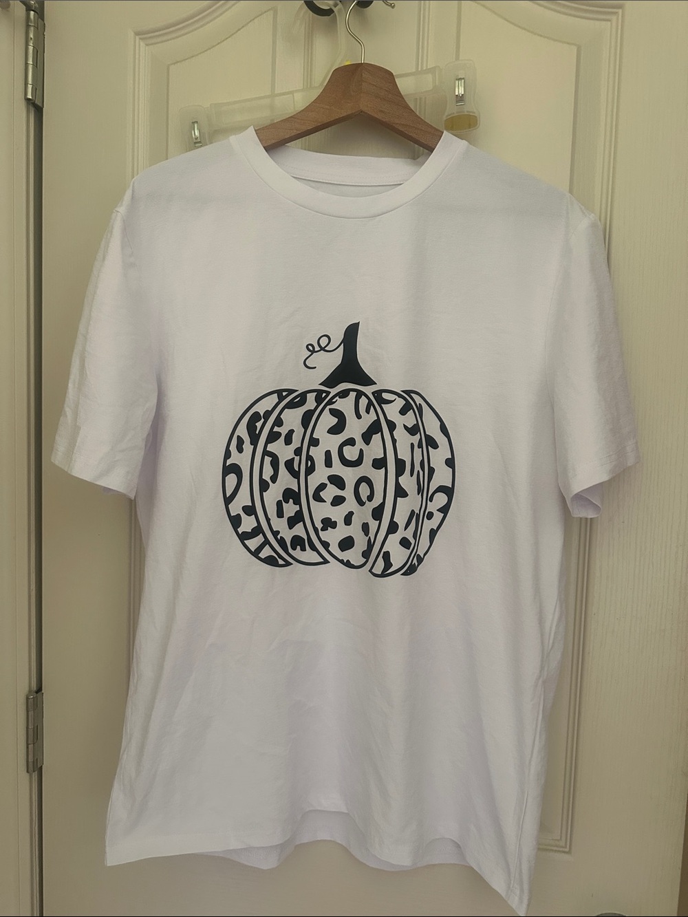 White Women’s Short Sleeve Tee with Black Leopard Pumpkin Graphic